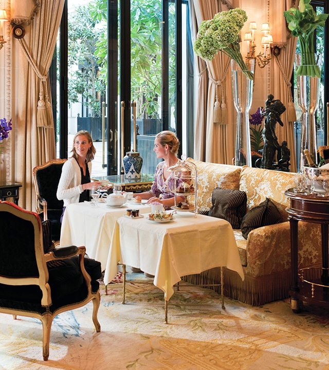Friends enjoy high tea at Le Galerie lounge at Four Seasons Hotel George V—Paris, France