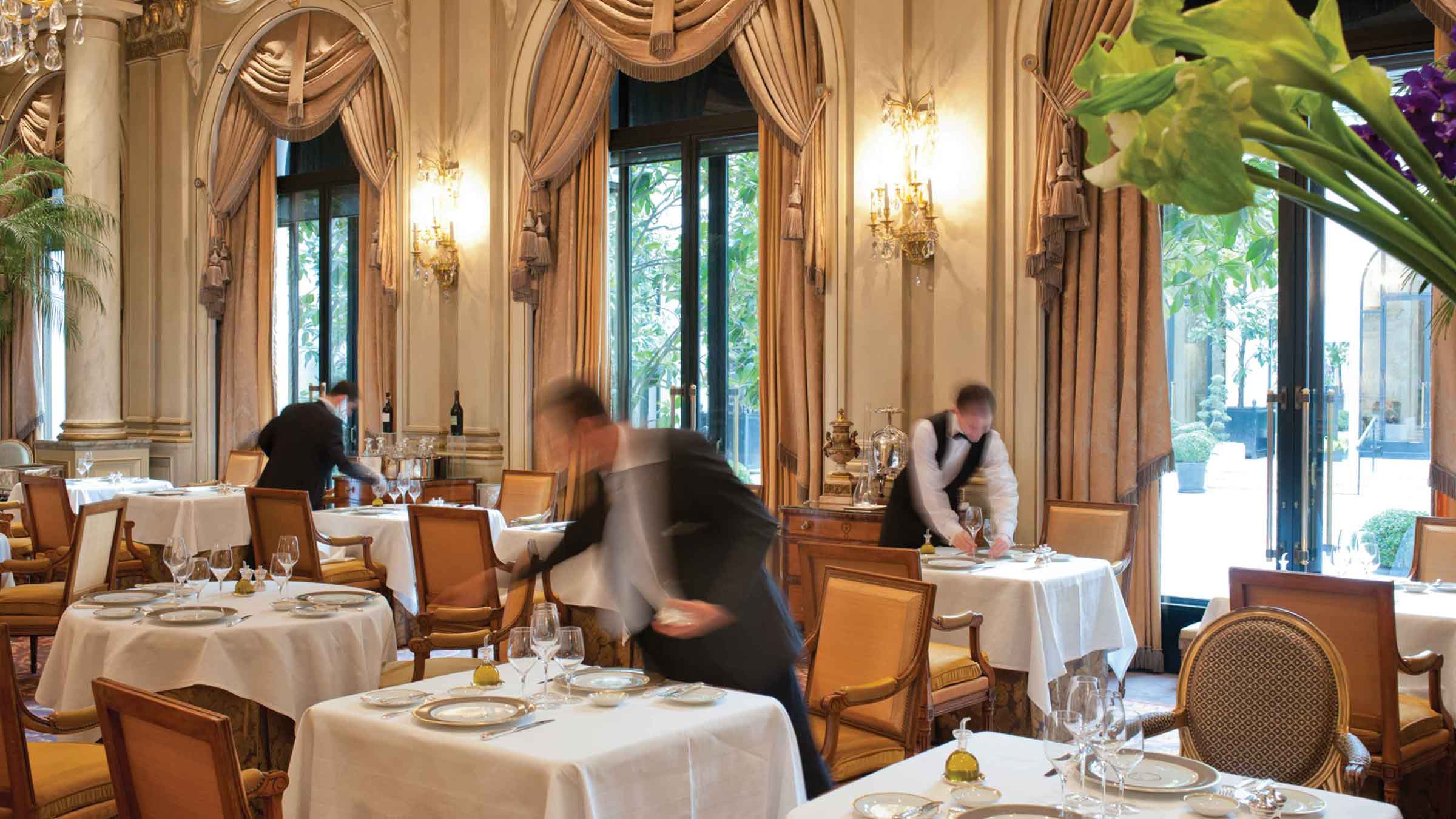 Waiters prepare the dining room at Le Cinq restaurant at Four Seasons Hotel George V—Paris, France