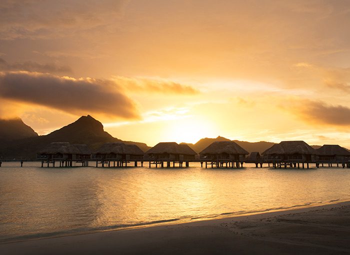 Overwater bungalows at sunset