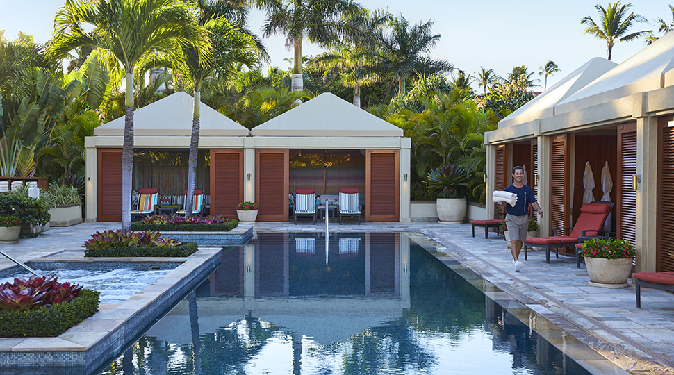 Pool Cabanas with pool staff holding towels