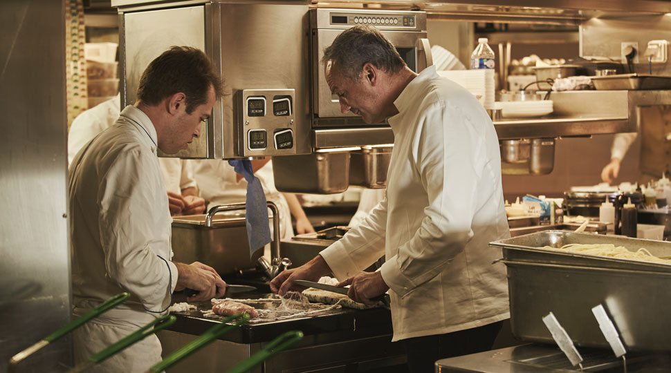 Chef Le Squer cooks in the kitchen at the Four Seasons Paris