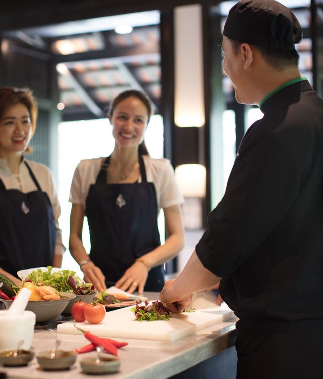 Two people taking chef class in Vietnam