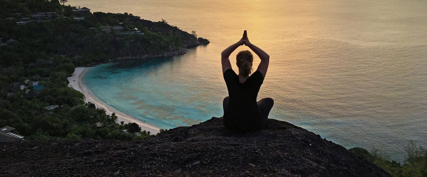 Yoga on a cliff in the Seychelles