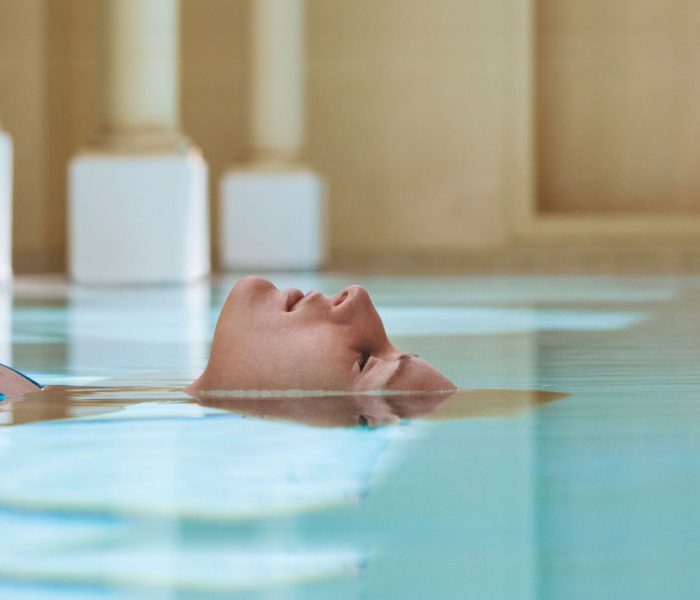 A woman submerging her body in water