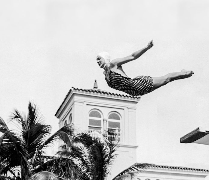 An old photo of a woman diving off a diving board