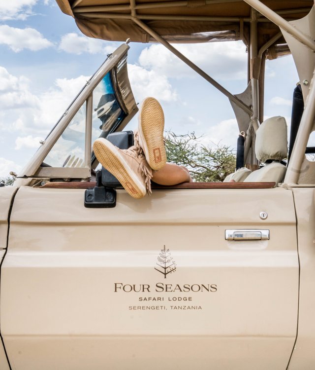 A pair of shoes peak out of a Four Seasons Serengeti Safari tour jeep.