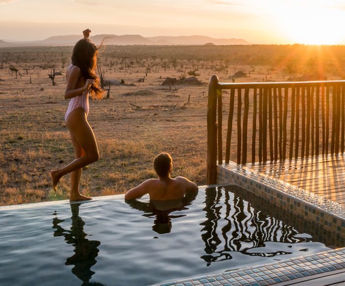 Photographer Robert Michael Poole and his partner, Marcy Yu, enjoying sunset at their private infinity pool at Four Seasons Safari Lodge Serengeti.
