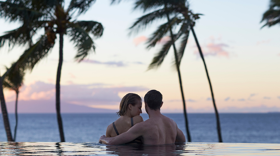 Couple Watching Ocean From Inifinity Pool In Maui