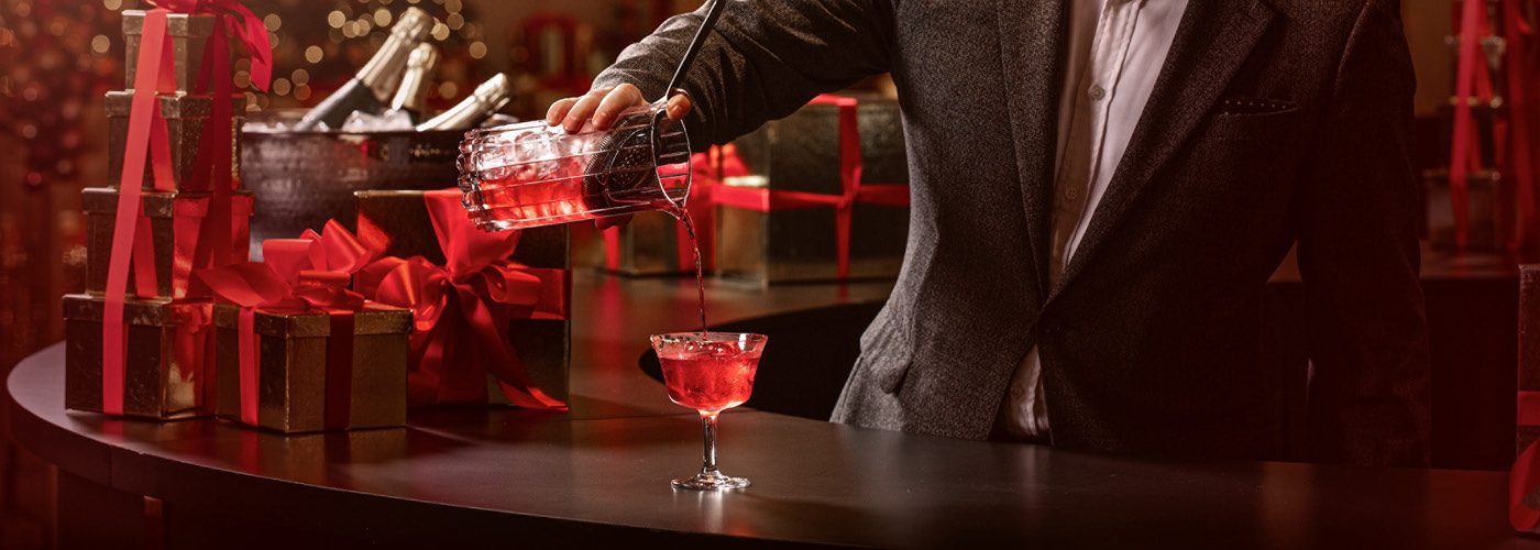 Mixologists pours a holiday cocktail