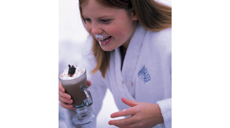 Young girl drinking hot cocoa
