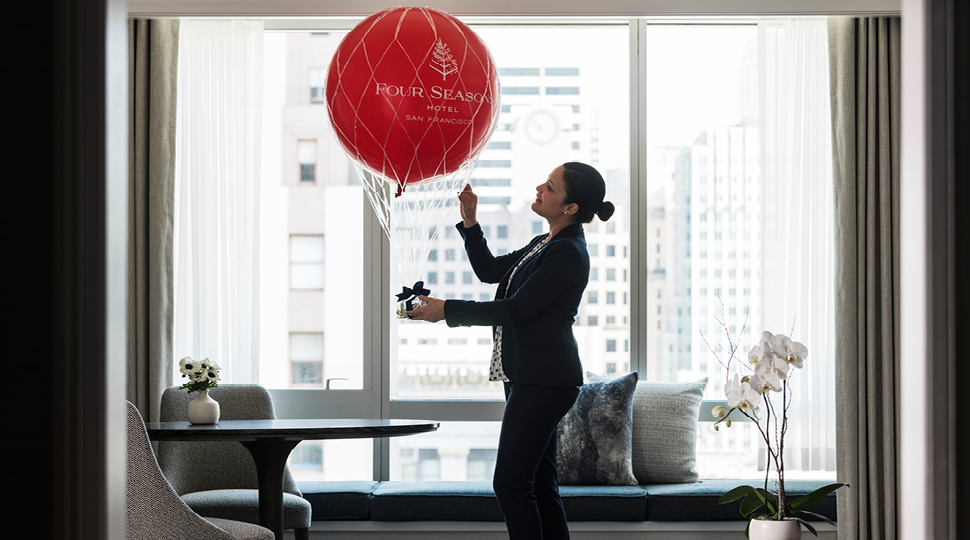 Woman in hotel room with balloon