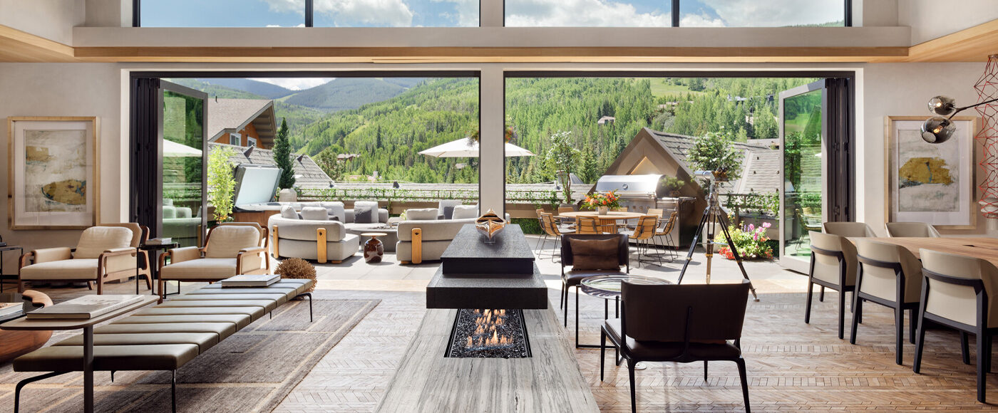 Mountain view from the large windows of a chic, modern living area