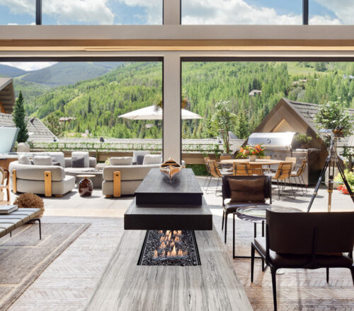 Mountain view from the large windows of a chic, modern living area