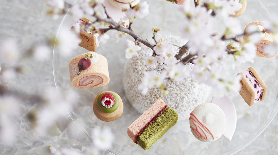 Close up of pastries surrounded by cherry blossom flowers