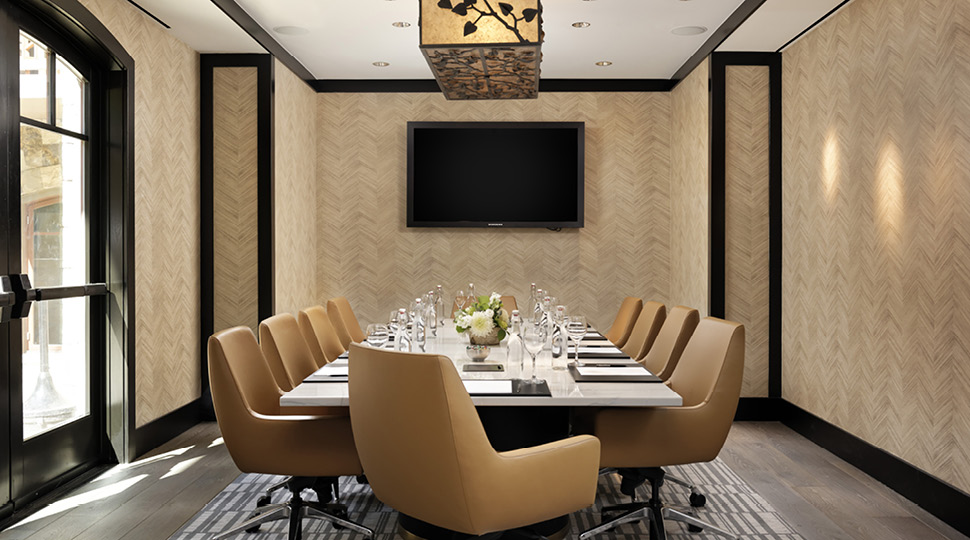 Meeting room with yellow chairs and chandelier