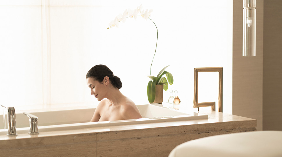 A woman bathes in a large bathtub