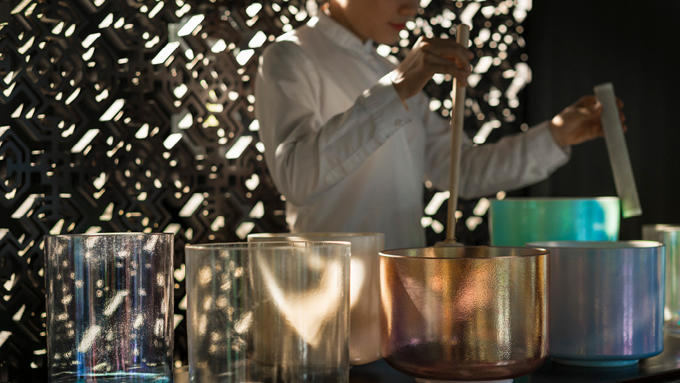 Quartz bowls arranged on table, person standing behind