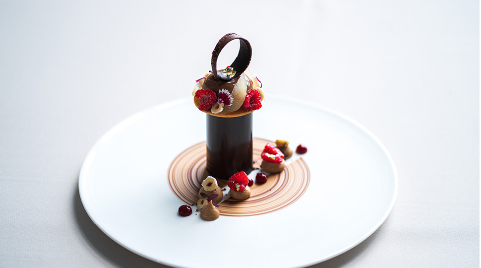 A chocolate dessert on a white plate