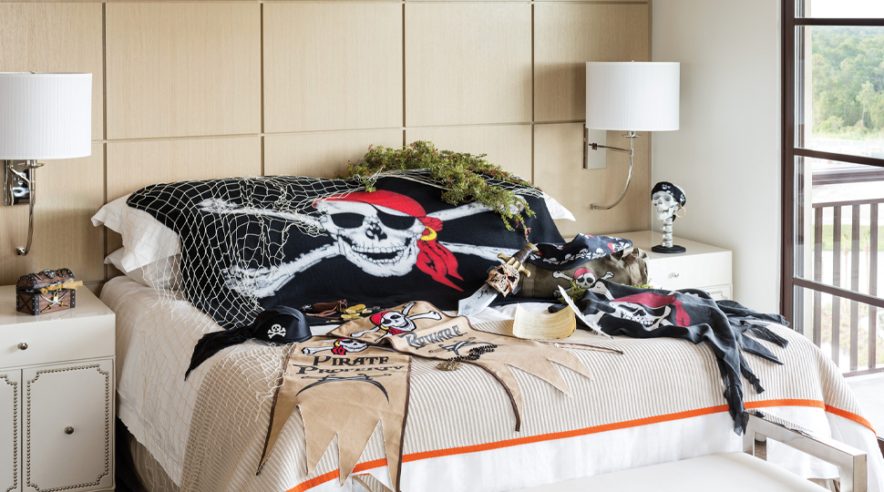 A bed filled with pirate-themed decorations