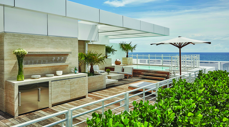 Large terrace with outdoor kitchen, lounge seating, umbrella and a plunge pool
