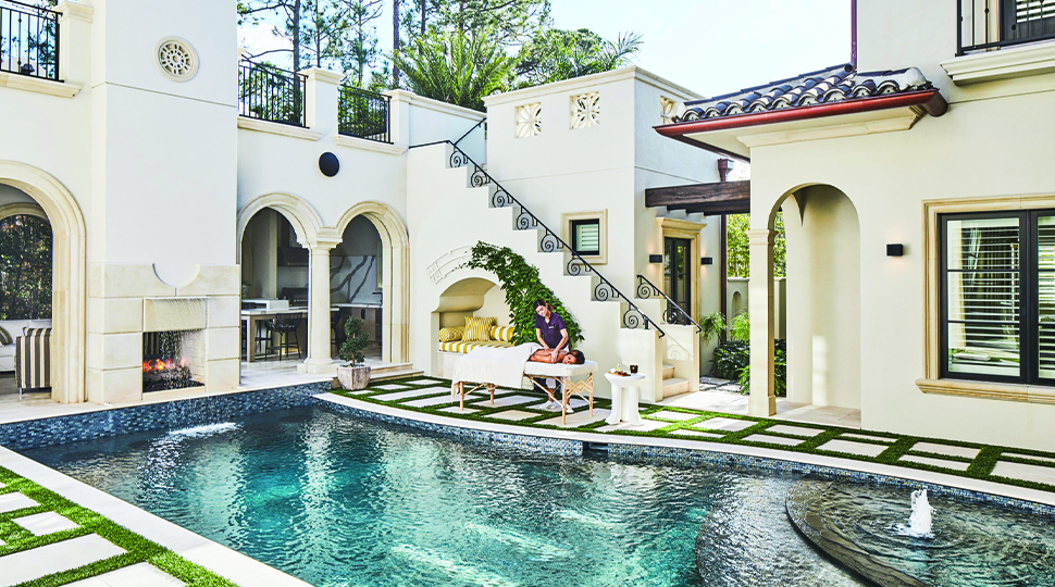 Outdoor pool surrounded by Spanish-style architecture
