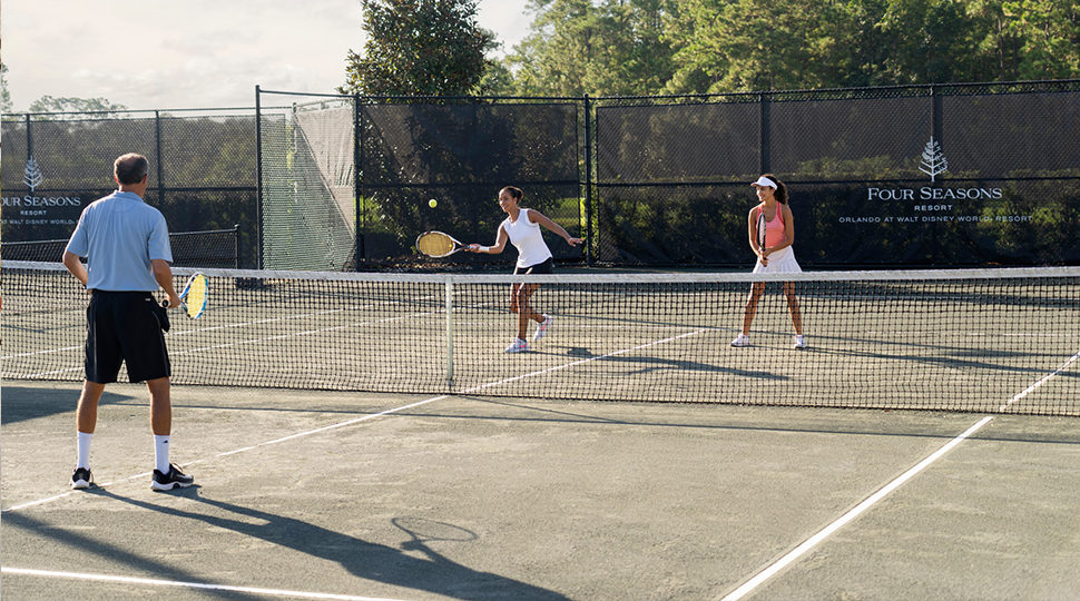 Three people playing tennis on a Har-Try court