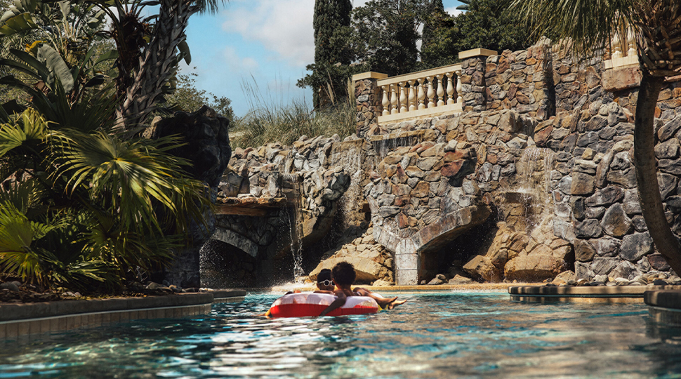 Two kids float on a lazy river