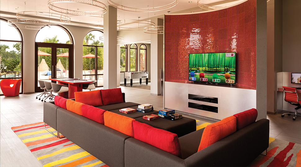 Teen lounge with red sofa and large-screen TV