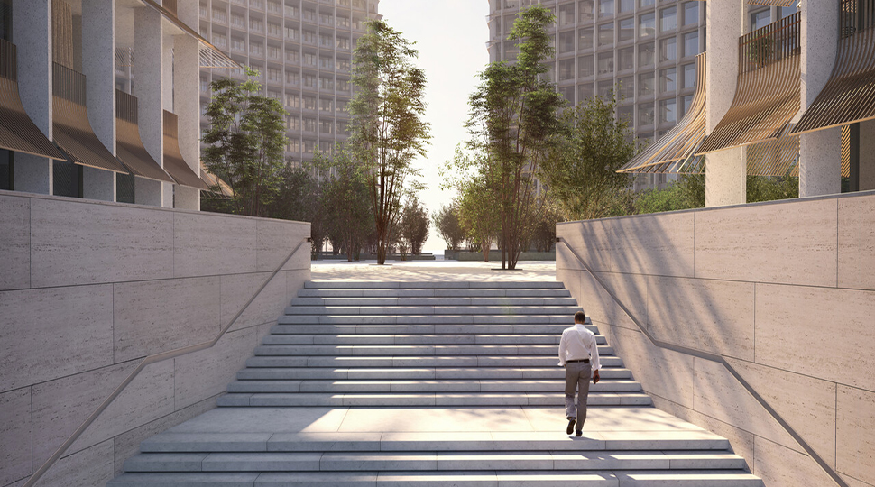 Person wearing white button-down shirt and grey slacks walks up a stone staircase toward an open plaza