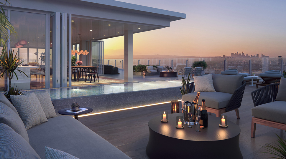 Rooftop terrace with covered dining area, plunge pool and open-air lounge seating with a coffee table holding three candles and two bottles of champagne